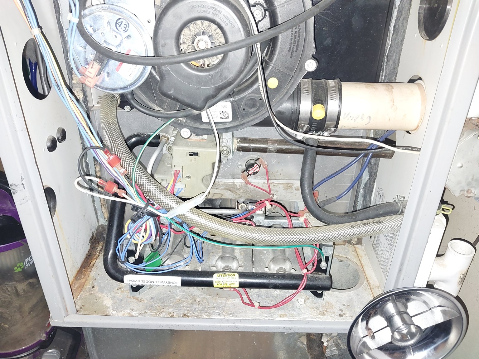 Inside a furnace. An open furnace cabinet showing internal equipment and connections.